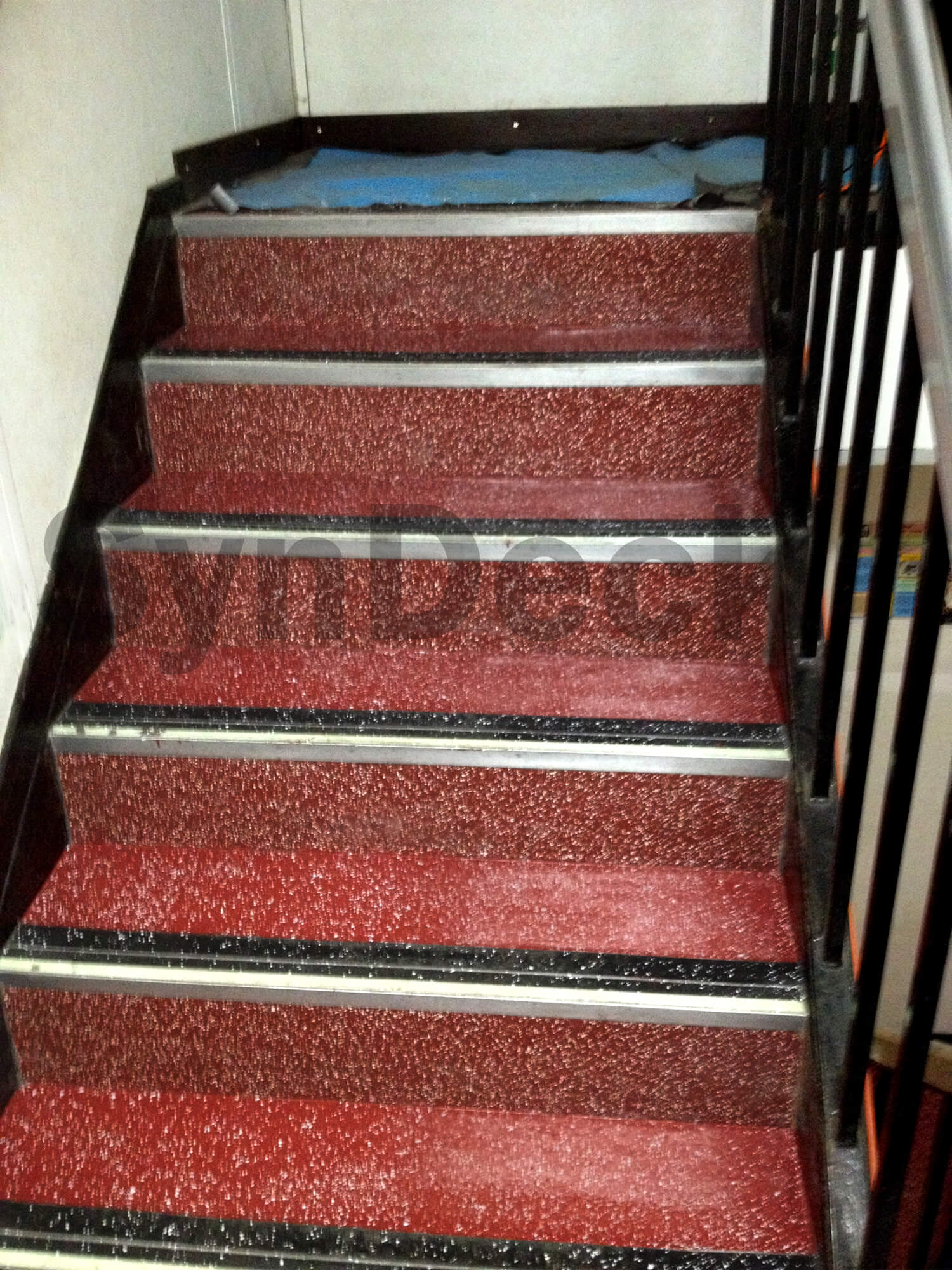 Image of Completed SynDeck Epoxy System with Flake in Red on Ferry Stairs