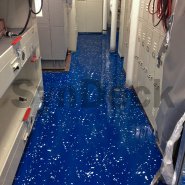 Completed SynDeck Epoxy Deco System, IMO Epoxy SS5000 in Navy Blue with Flake on Navy Vessel Storage Room Floor. Bond Coat SS1222, Underlayment SS1290, IMO Epoxy SS5000 with Flake, SS5000 Top Coat Clear