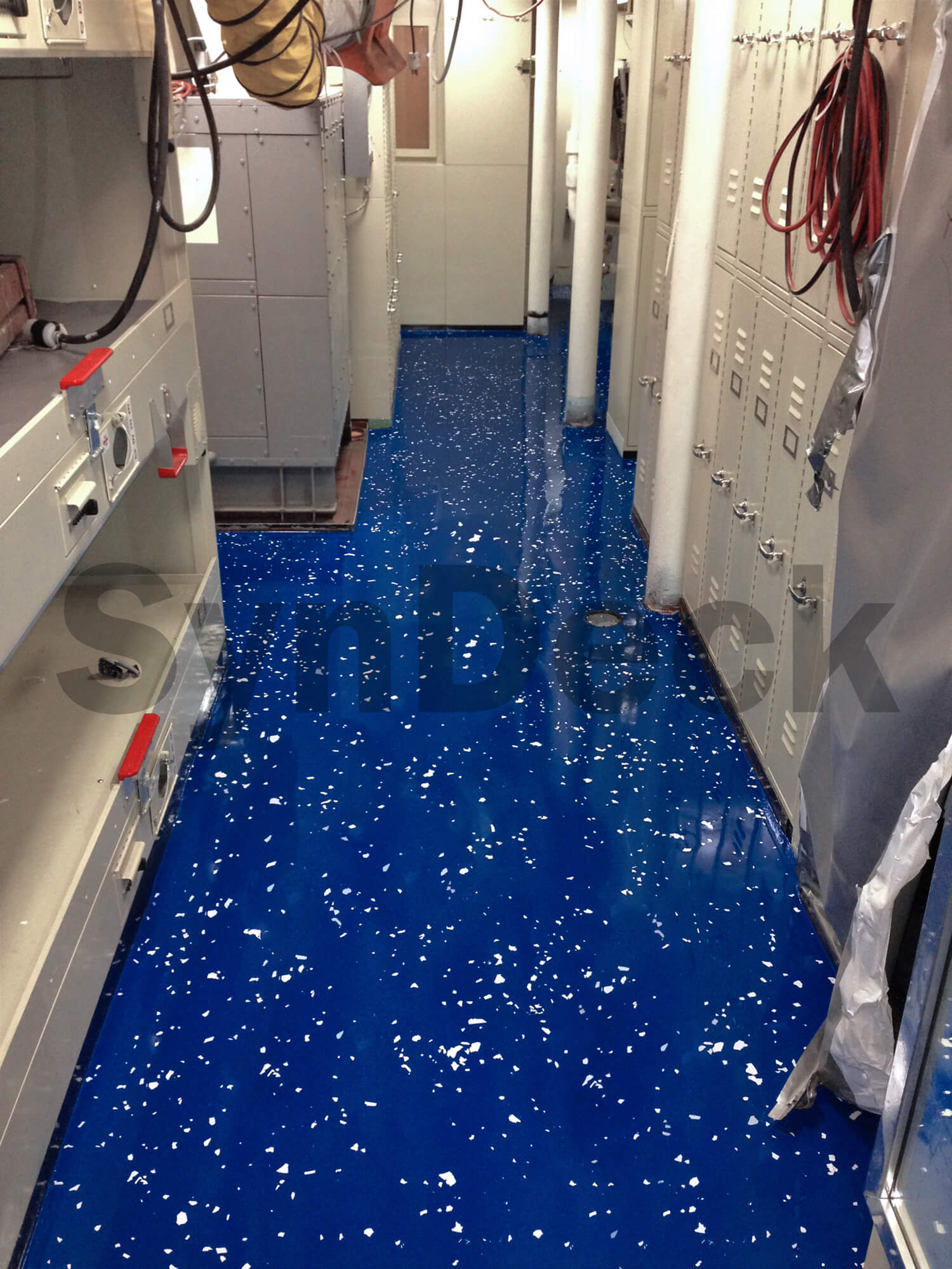 Image of Completed SynDeck Epoxy Deco System, IMO Epoxy SS5000 in Navy Blue with Flake on Navy Vessel Storage Room Floor. Bond Coat SS1222, Underlayment SS1290, IMO Epoxy SS5000 with Flake, SS5000 Top Coat Clear