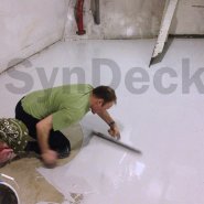 Application of SynDeck Flex IMO System Grey with Flake on Navy Gym Floor
