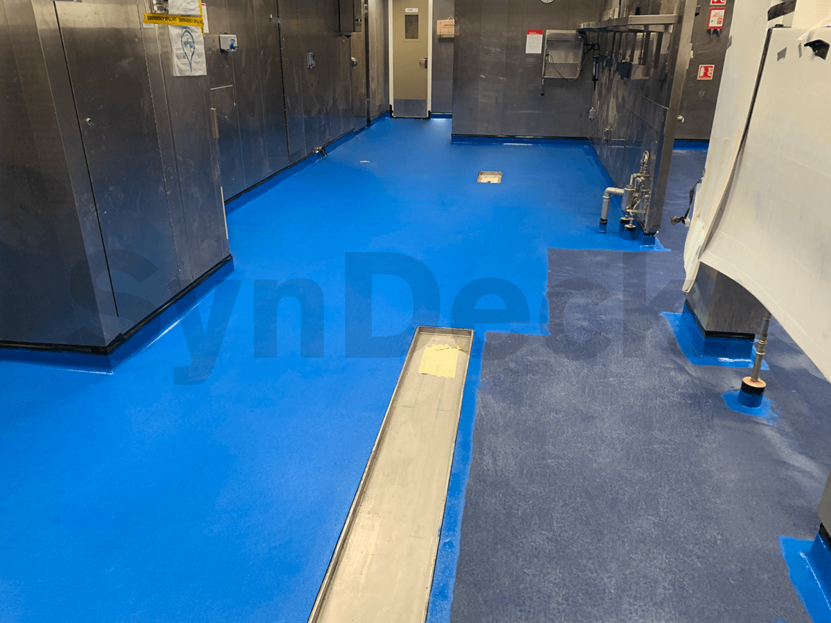 Image of Application In Progress of SynDeck IMO Epoxy SS5000 Navy Blue 5015 over Blue Quartz, 1st Layer